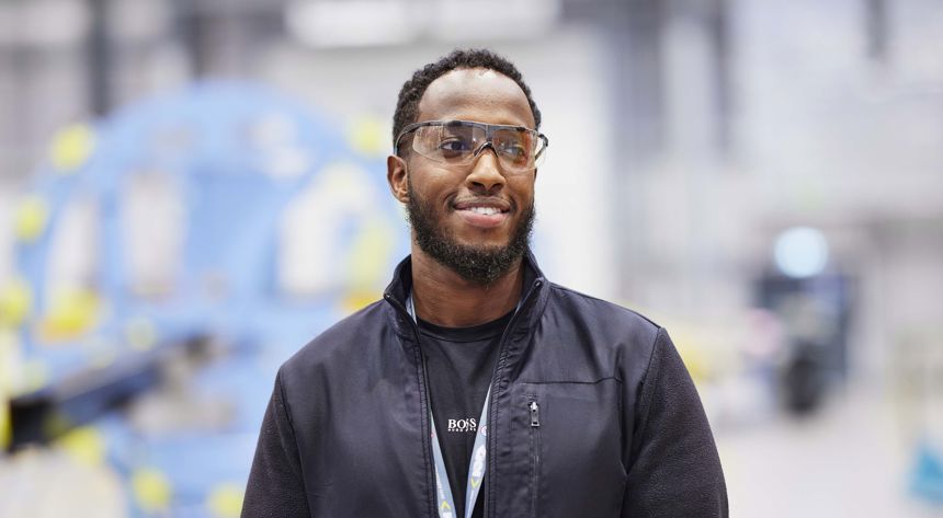 Man standing in shop floor looking off camera